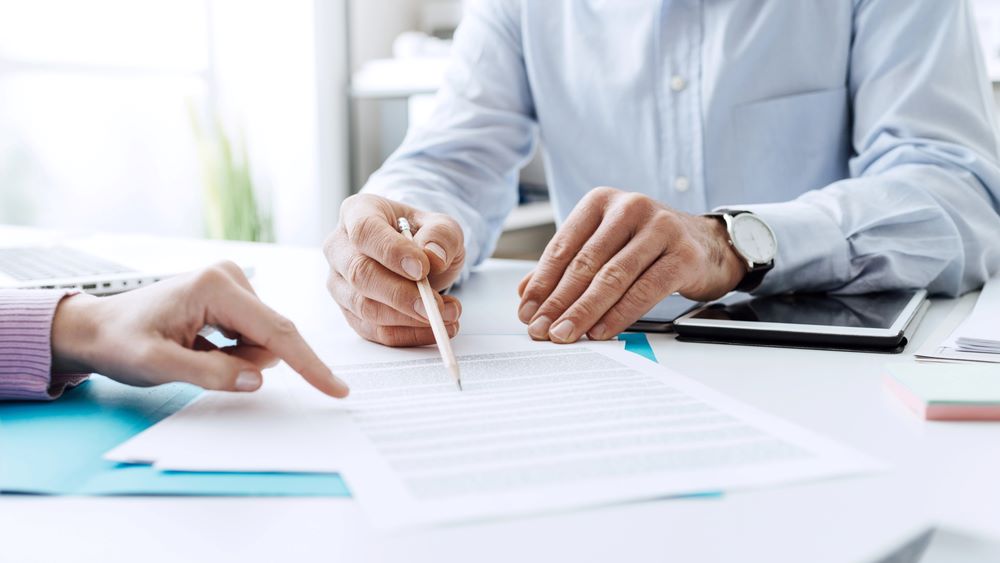 Image of business people negotiating a contract, featuring JMSurety and highlighting 'DMEPOS Bonds,' ensuring it aligns with the page's context on bonding for Durable Medical Equipment suppliers.