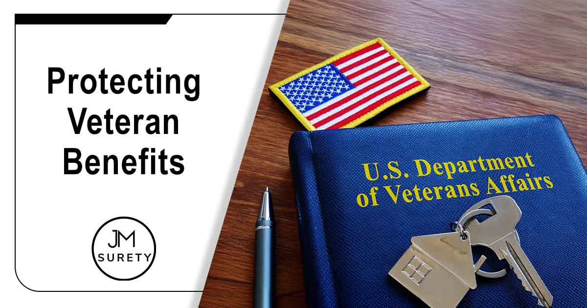 Image of VA loan documents from the U.S. Department of Veterans Affairs alongside an American flag, featuring JM Surety and highlighting Protecting Veteran Benefits, ensuring it aligns with the page's context.